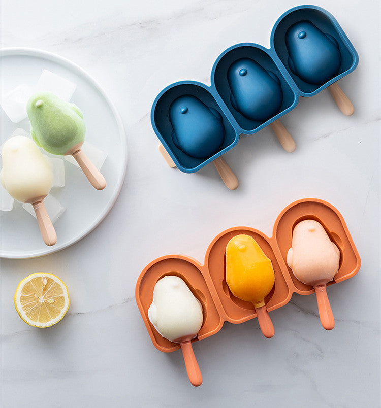 Penguin-shaped silicone ice cream molds in blue and orange