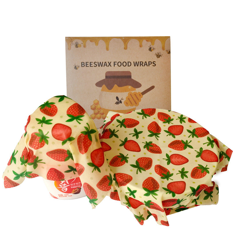 Yellow beeswax food wraps with red strawberry pattern