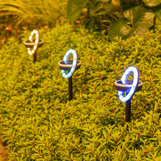 Solar-powered multicolored LED garden lights on black stakes