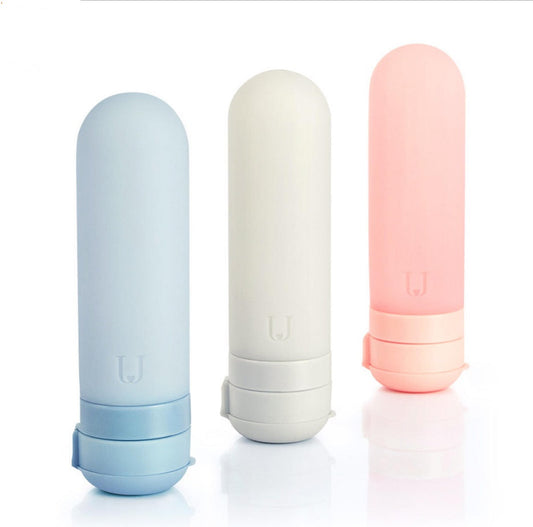 Eco-Friendly Refillable Travel Bottles in Light Blue, White, and Pink