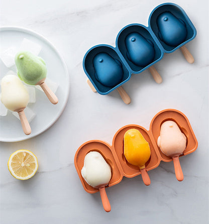 Penguin-shaped silicone ice cream molds in blue and orange