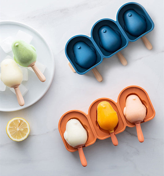 Penguin-shaped silicone ice cream molds in blue and orange