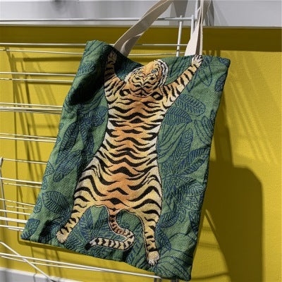 Green tote bag with tiger and leaf pattern