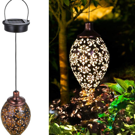 Solar-powered bronze garden lantern with intricate cut-out patterns