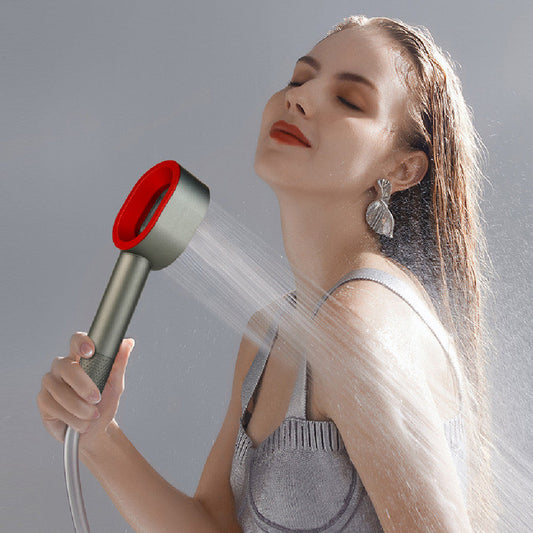 Silver handheld shower head with red nozzle