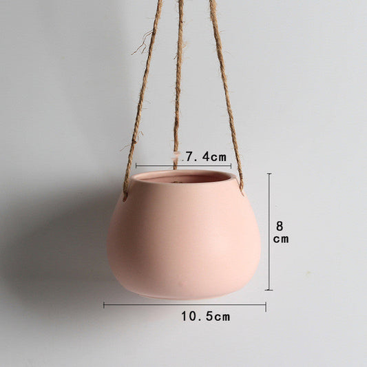Light pink ceramic hanging planter with a wide opening