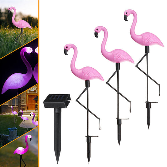 Solar-Powered Pink Flamingo Garden Lights in a garden setting