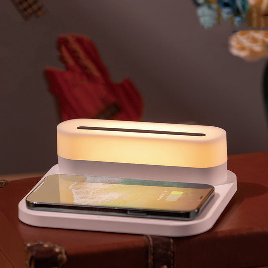 Wireless charging station with LED night light on a bedside table