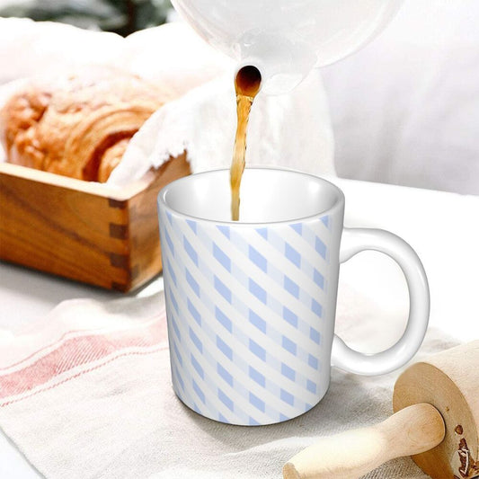 White ceramic mug with light blue diagonal stripes