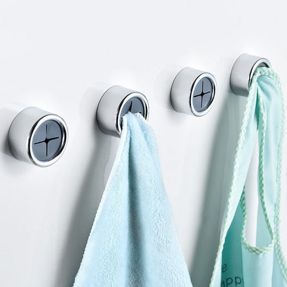 Circular wall-mounted towel holder in silver with black accents