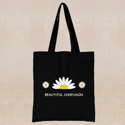 Black tote bag with white and yellow daisy design