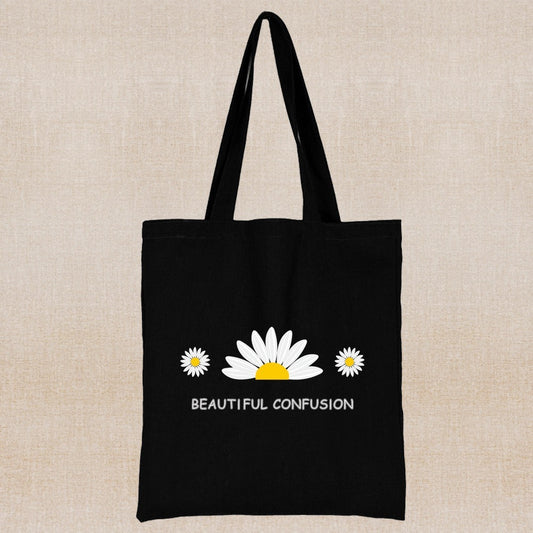 Black tote bag with white and yellow daisy design