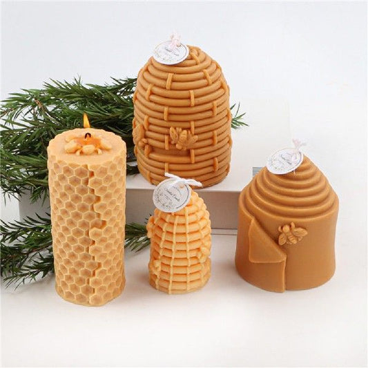 Natural beeswax candles in various shapes with honey tones