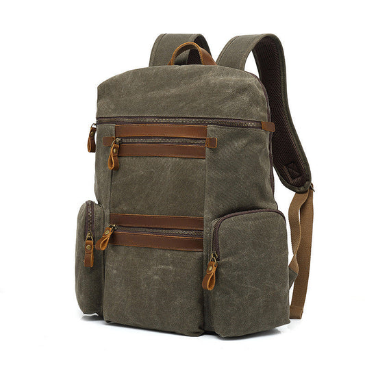 Olive green canvas backpack with brown leather accents and multiple compartments