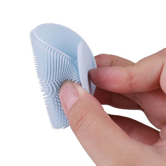 Light blue silicone face scrubber with an oval shape and textured surface