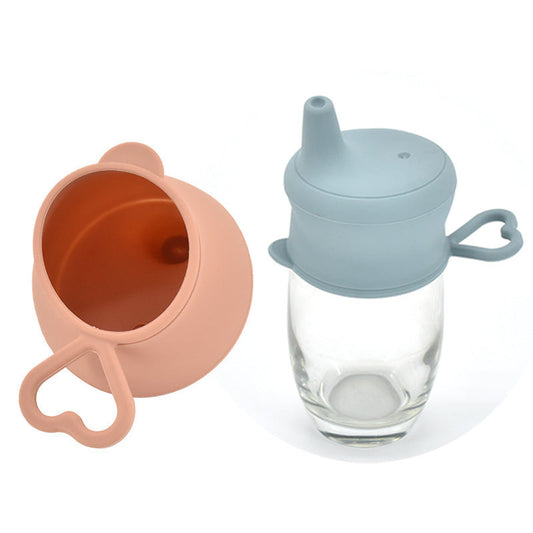 Light blue and peach silicone sippy cup lid with spout and handle